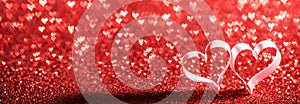 Red ribbon hearts on glitters