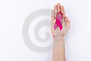 Red ribbon over palm. White background