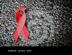 Red ribbon red ribbon on a stone, world aids day concept