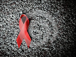 Red ribbon red ribbon on a stone, world aids day concept