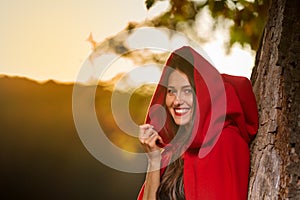 Red Riding Hood at sunset in the forest