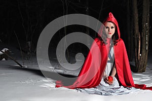 Red Riding Hood in the winter night forest