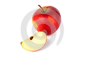 Red ripe apple with fresh sliced apple piece isolated on white