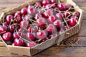 Red ripe cherries, red cherries on wooden table, brown wooden background