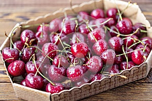 Red ripe cherries, red cherries on wooden table, brown wooden background