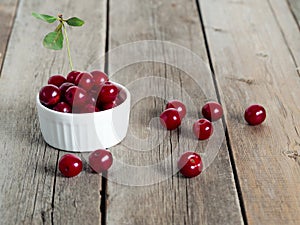 Red ripe cherries on rustic weathered wooden table