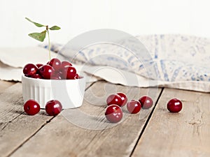 Red ripe cherries on rustic weathered wooden table