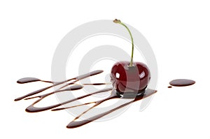 Red ripe cherry in liquid chocolate isolated on white background. Fondue cherry in hot chocolate