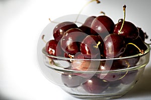 Red ripe fresh cherries in glass bowl