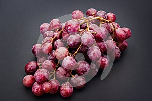 Red ripe grape over grey