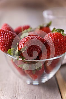 Ripe organic strawberries in a glass bowl.