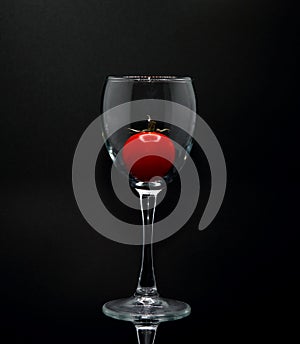 Red ripe tomato in a glass goblet. Natural product.