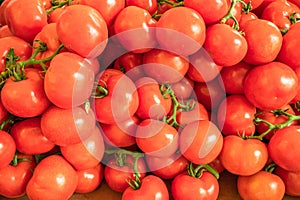 Red ripe tomatoes closeup on the farm market stall. Food background