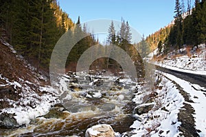 Red river, white ice and green firs.