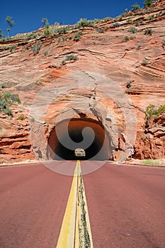 Red road that leads into a tunnel, USA