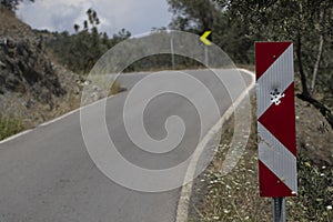 Red road traffic sign full of bullet holes. Close up