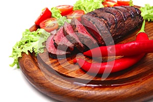 Red roast meat on wooden plate