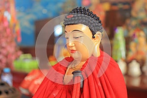 red robed meditating buddha statue