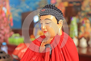 red robed meditating buddha statue photo