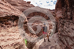 Red Rock Canyon - Woman standing in gorge of rock formation with scenic view of limestone rock of Calico Hills, Nevada, USA