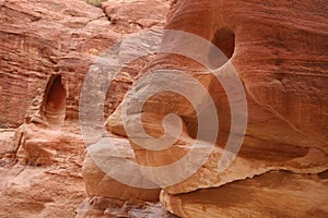 Red rock with a face, as you walk down the Siq towards Petra, Jordan