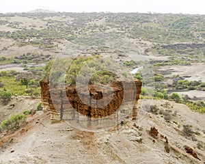 Red rock formation in landscape Oldupai Gorge