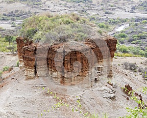 Red rock formation in landscape Oldupai Gorge