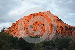 Red rock hill in New Mexico under blue cloudy sky