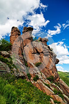 The red rock on the summer grassland