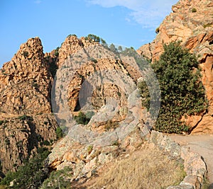 Red rocks of Badlands mountains called Calanques of Piana in Cor