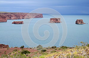 Red rocks in the blue lake water