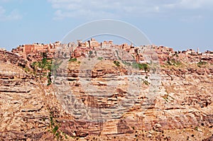 Red rocks and decorated old houses, the ancient walls of Kawkaban, Yemen