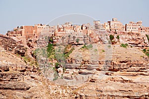 Red rocks and decorated old houses, the ancient walls of Kawkaban, Yemen