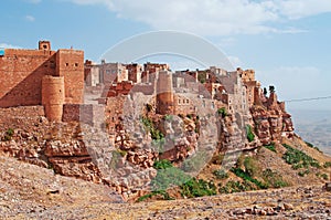 Red rocks and decorated old houses, the ancient walls of Kawkaban, Yemen