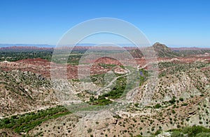 Red rocks and green valley mountain landscape photo