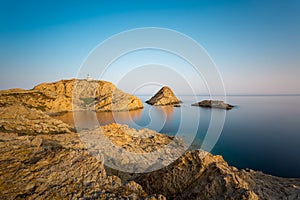 Red rocks and lighthouse of Ile Rousse in Corsica