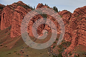 Red rocks seven oxen, coniferous trees on top of rock, 7 bulls, gorge Jety-Oguz. Travel destination place, Kyrgyzstan