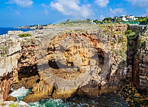 View of Red rocky cliffs, Boca do Inferno chasm. District of Lisbon, Portugal photo