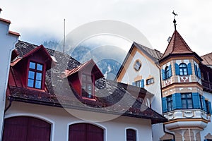 Red roof of an old building with fog in the mountains in the morning