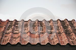 Red roof tiles texture with blue sky.