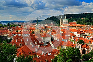 Red roofs in the city Prague. Panoramic view of Prague from the Prague Castle, Czech Republic. Summer day with blue sky with cloud