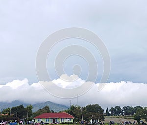 Red rooftop with cumullus clouds