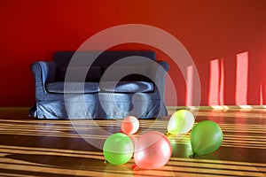 Red room with blue sofa with balloons
