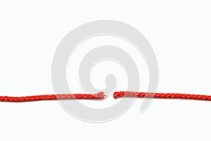 Red rope cut into two parts on a white isolated background