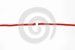 Red rope cut into two parts on a white isolated background