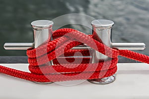 Red rope fasten on stake of yacht photo