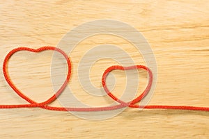 Red rope heart on wood plate valentine content