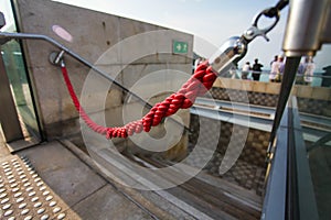 Red rope like do not enter sign. unauthorized entry is prohibited. Closeup, shallow focus.