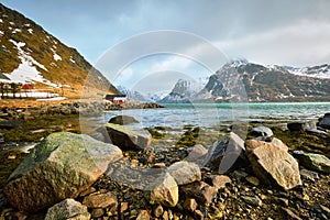 Red rorbu house and fjord in Norway