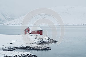 Red rorbu house in winter, Lofoten islands, Norway